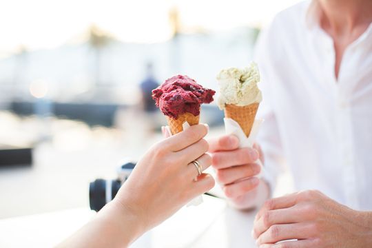 Couple sharing ice cream cones